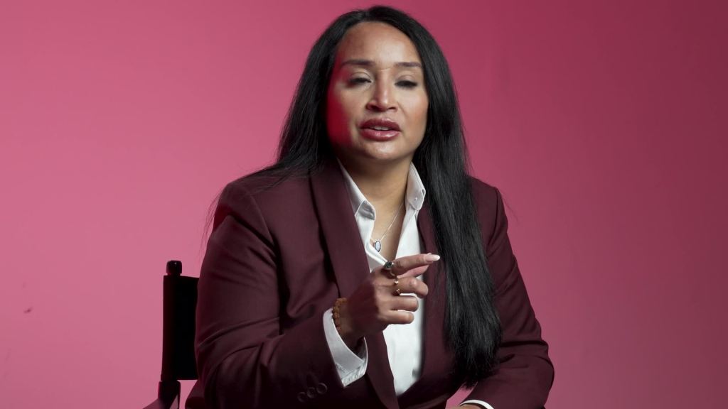 Caylene Salii speaking on the pink interview set during her Women in Power TV documentary